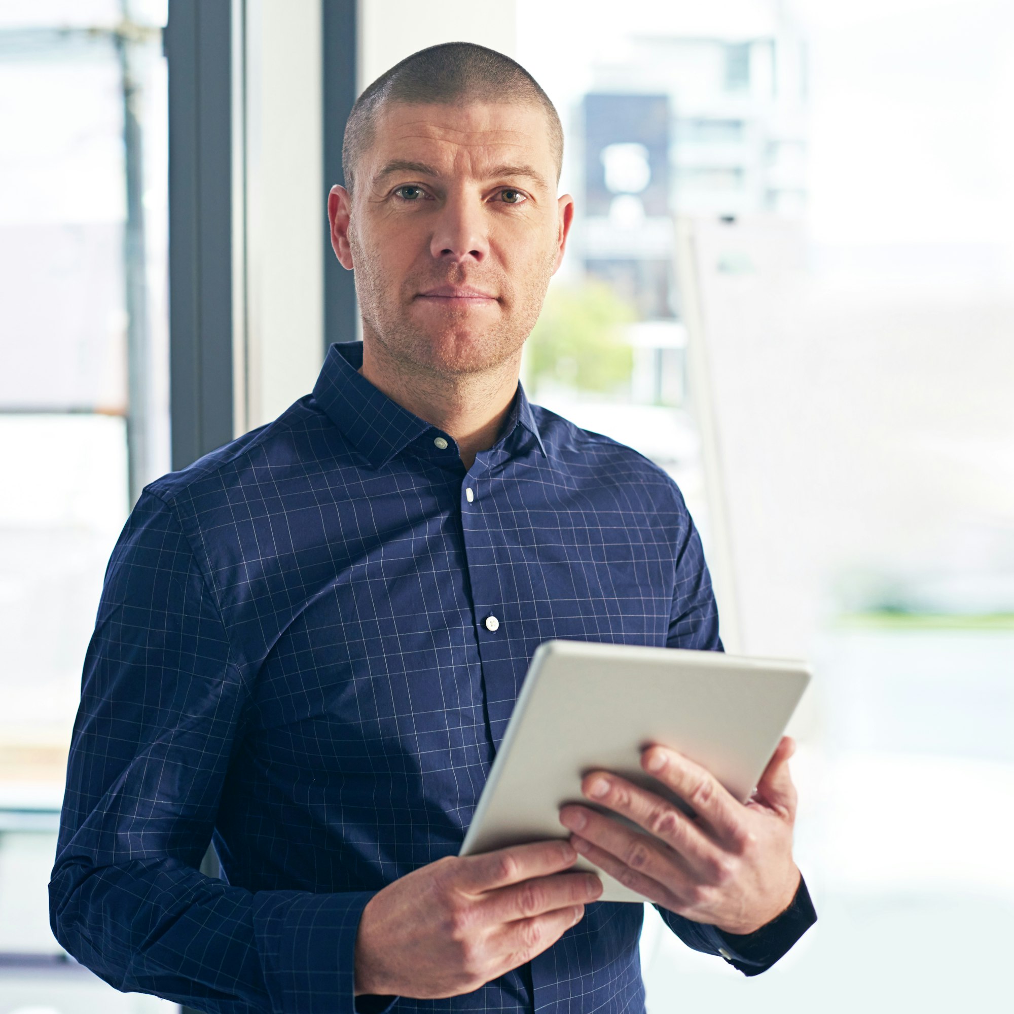 Portrait of a businessman using a digital tablet in a modern office